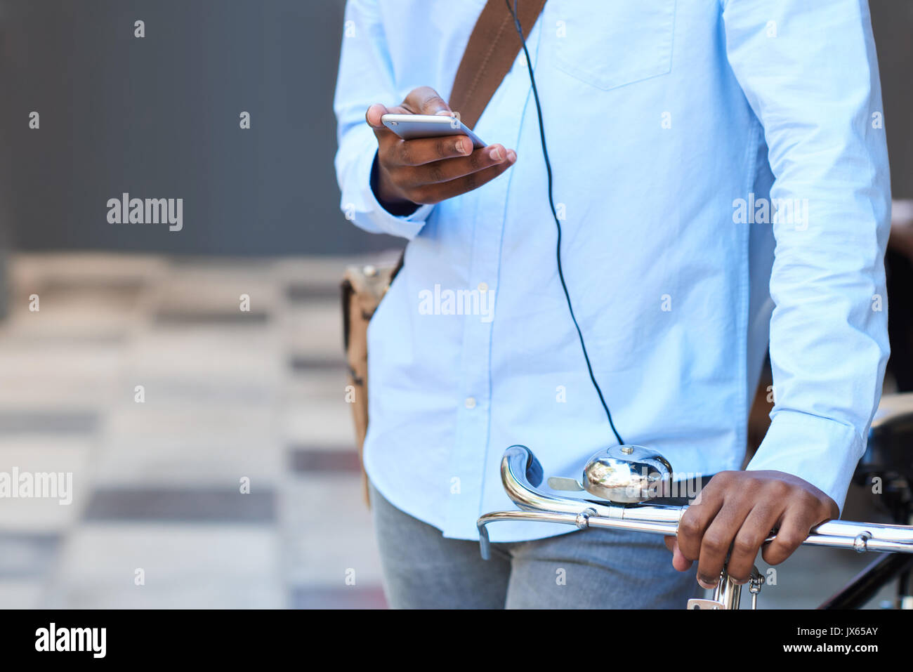 Closeup of a man with his bike using a cellphone Stock Photo