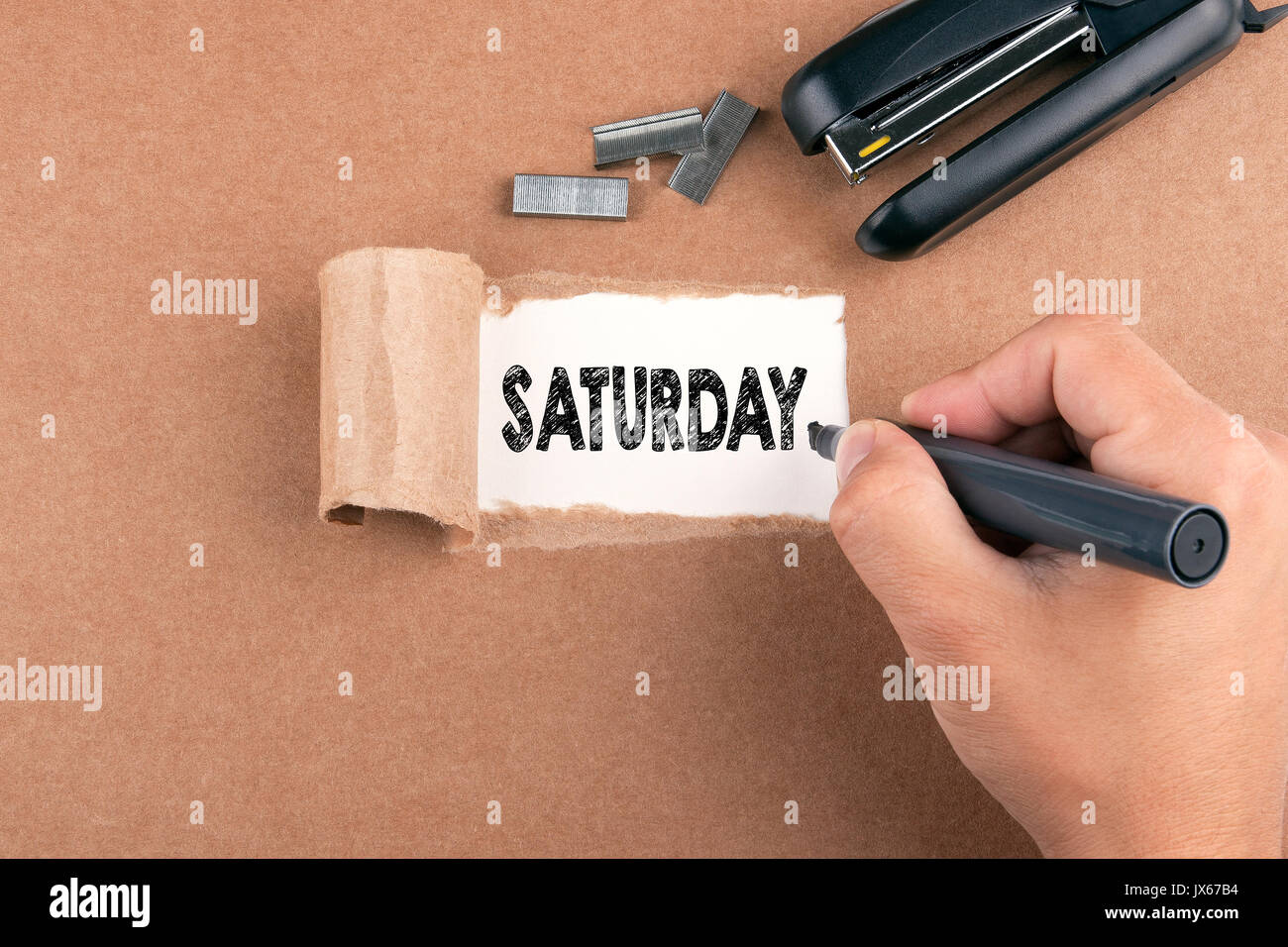 Saturday. Inscription in window of torn paper Stock Photo - Alamy