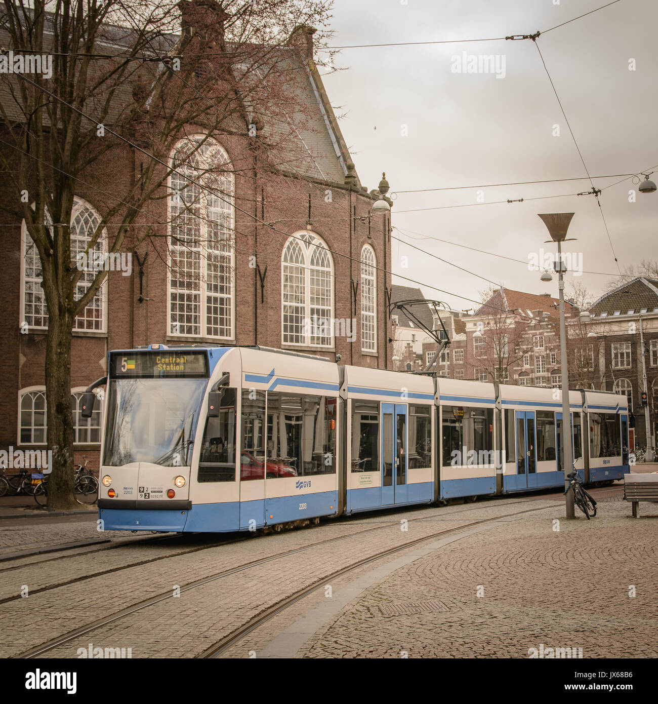 Tram train in Amsterdam (Netherlands). March 2015. Squared format. Stock Photo