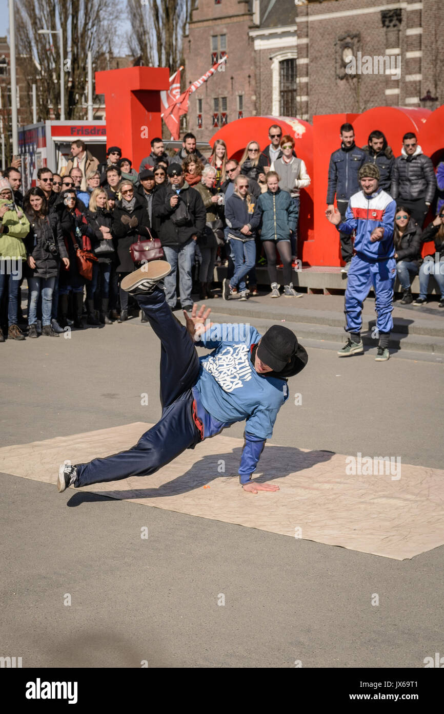 Breakdancer performing in Museumplein in Amsterdam (Netherlands). March, 2015. Portrait format. Stock Photo