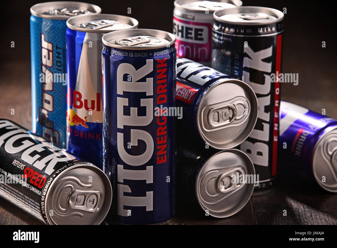 POZNAN, POLAND - JULY 27, 2017: Cans of popular global energy drinks, beverages containing stimulant drugs and marketed as providing mental and physic Stock Photo