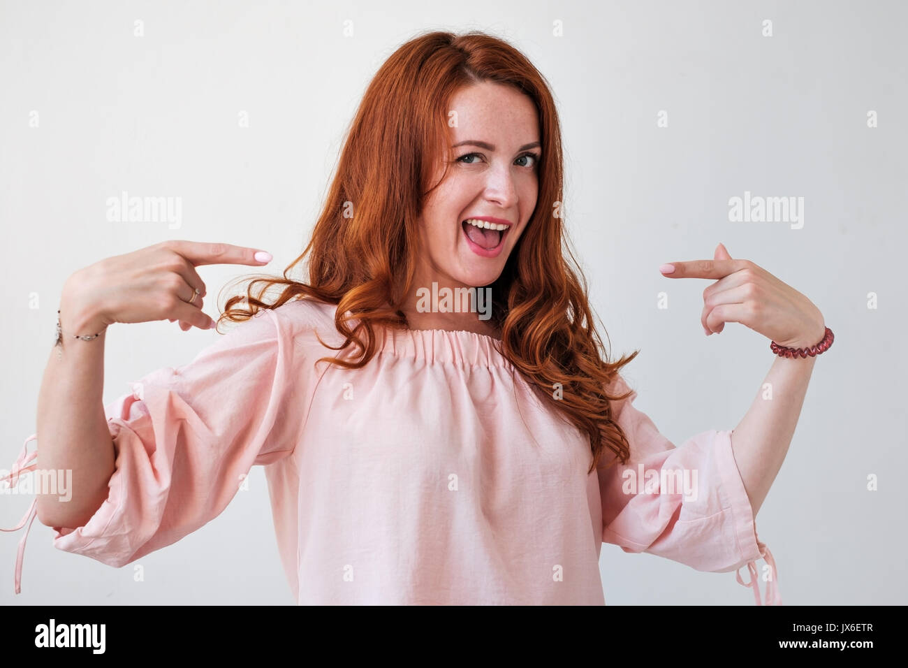 Portrair of caicasian red haired woman proud of herself. Stock Photo