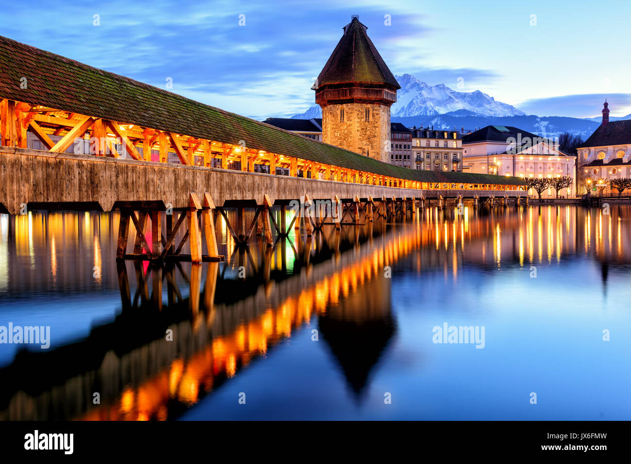 Wooden Chapel Bridge, Water Tower and Mount Pilatus in the Old Town of Lucerne, Switzerland, in the late evening light Stock Photo
