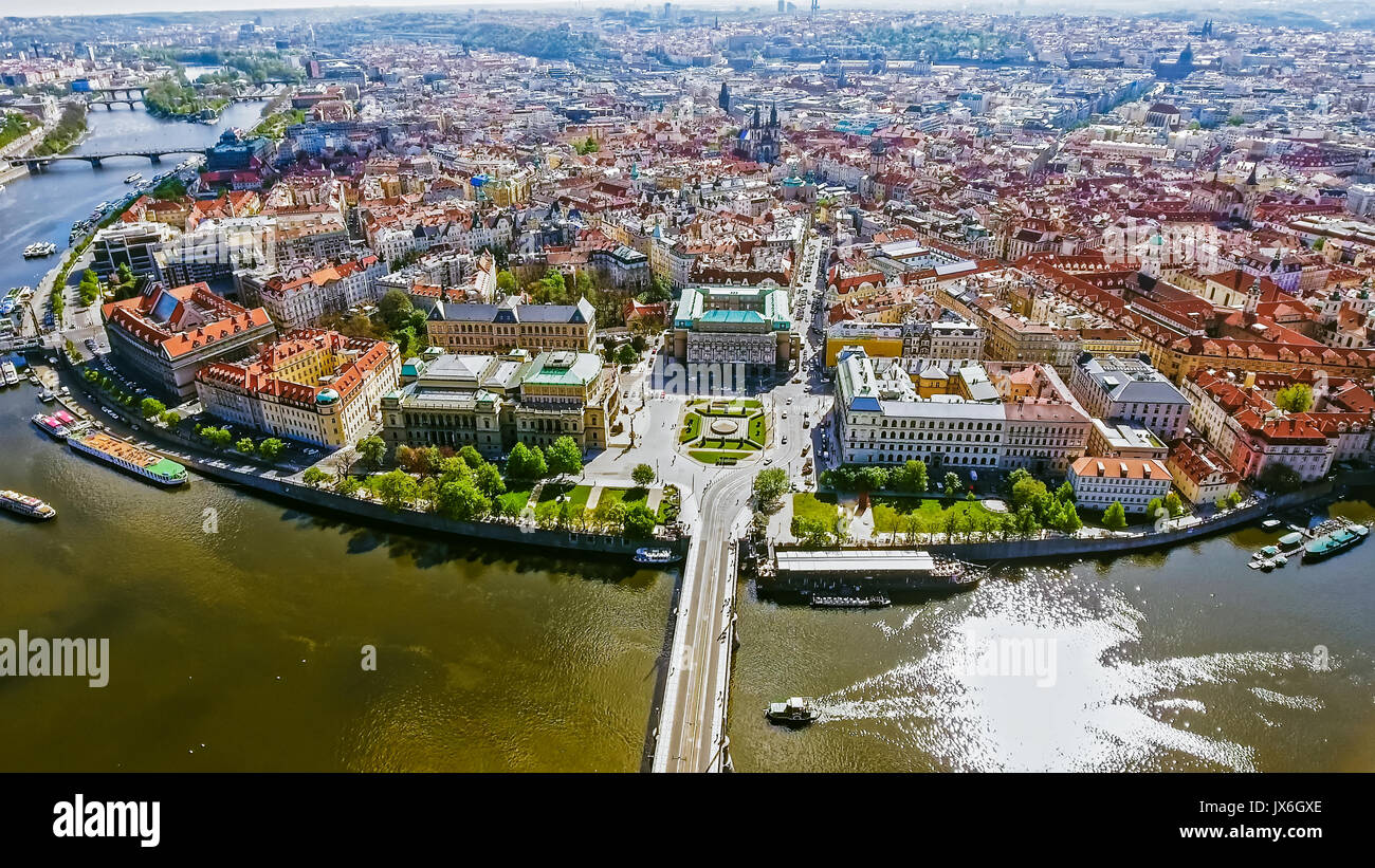 Aerial Bird Eye View of Prague Center Old Town Cityscape in Czech Republic feat. Vltava River and Boats on a Sunny Day Stock Photo