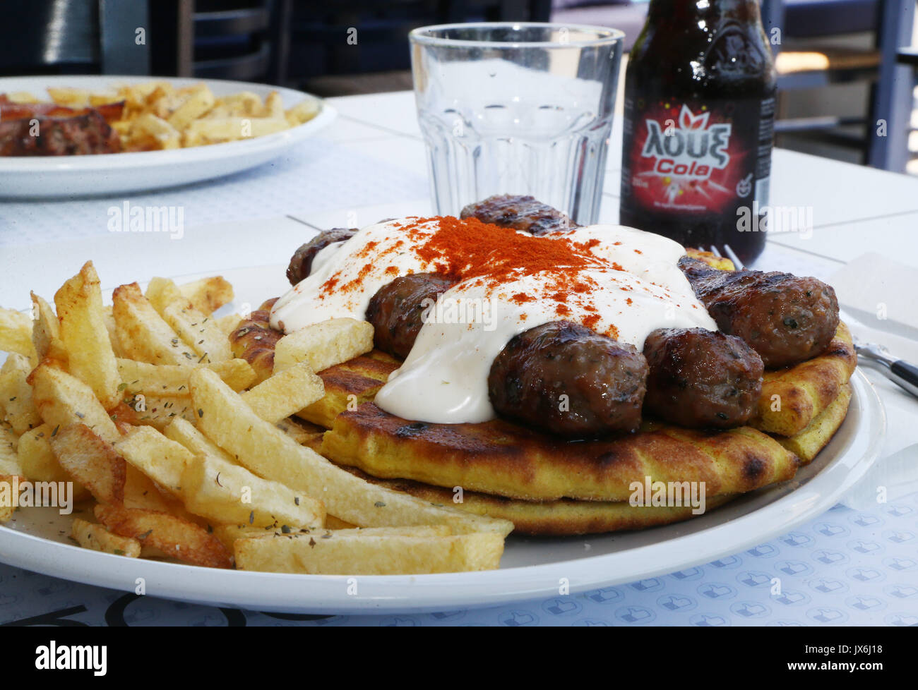 Greek traditional food, kebab under yogurt sauce tomato and paprika