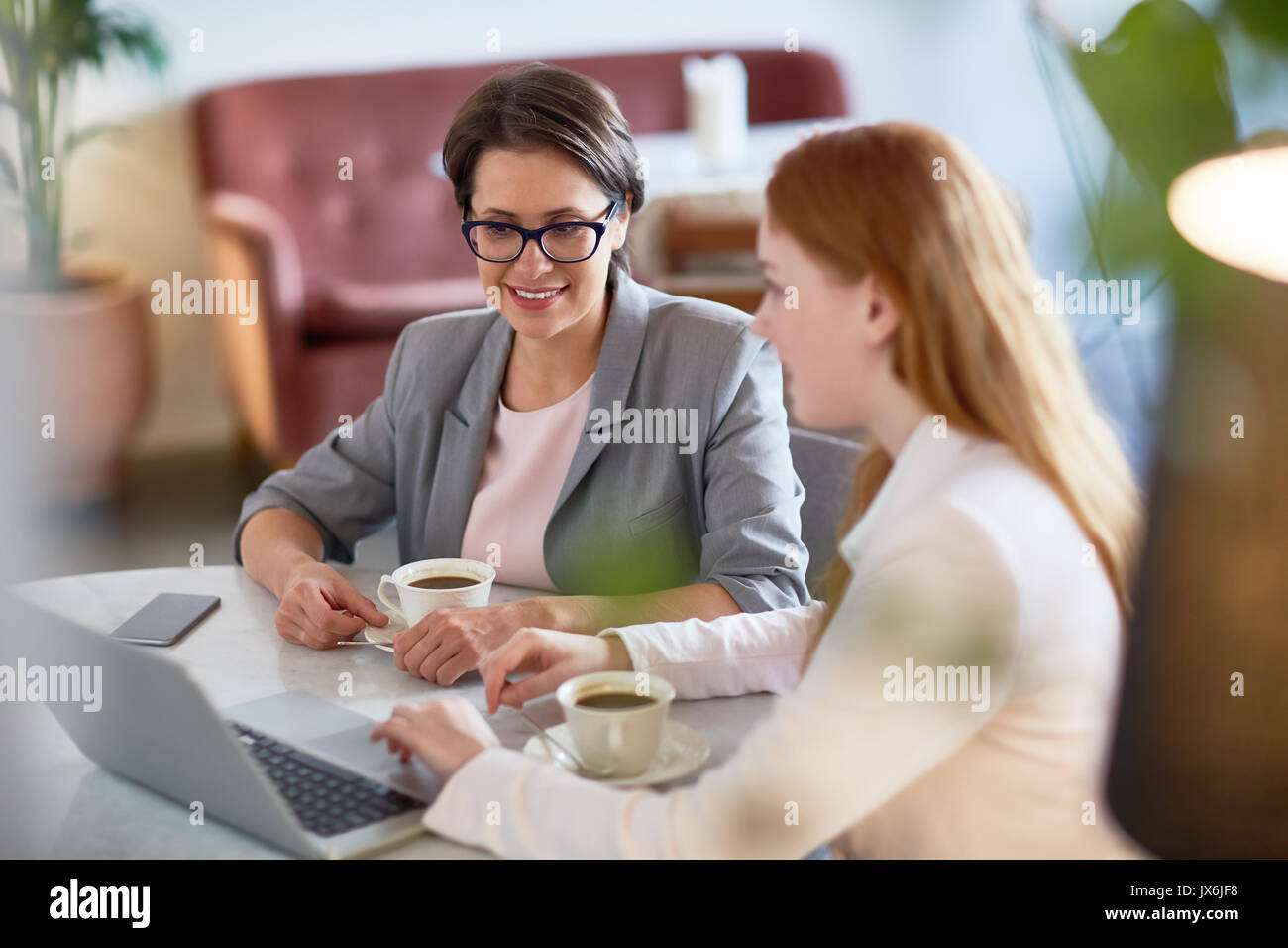 Productive Project Discussion at Coffeehouse Stock Photo