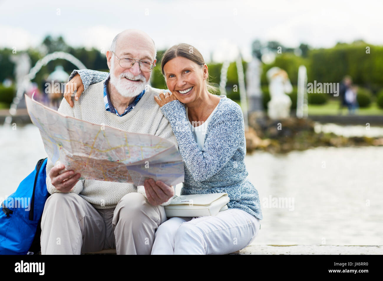 Seniors with map Stock Photo - Alamy