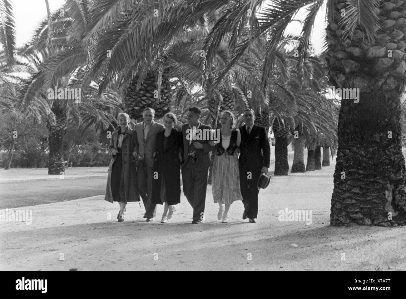 Six People Walking Arm In Arm Along Street Lined In Palm Trees Stock Photo Alamy Six People Walking Arm In Arm Along Street Lined In Palm Trees Stock Photo Alamy