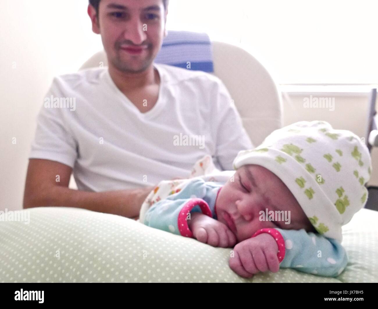 Hispanic uncle with his twoweekold niece Stock Photo Alamy