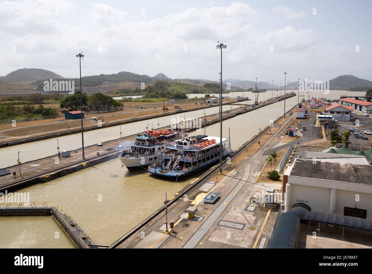 Two passenger vessels are positioned in the Miraflores Locks of the Panama Canal. Stock Photo