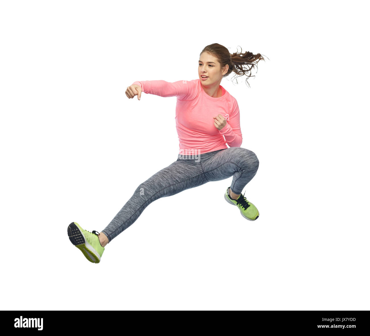 happy sporty young woman jumping in fighting pose Stock Photo