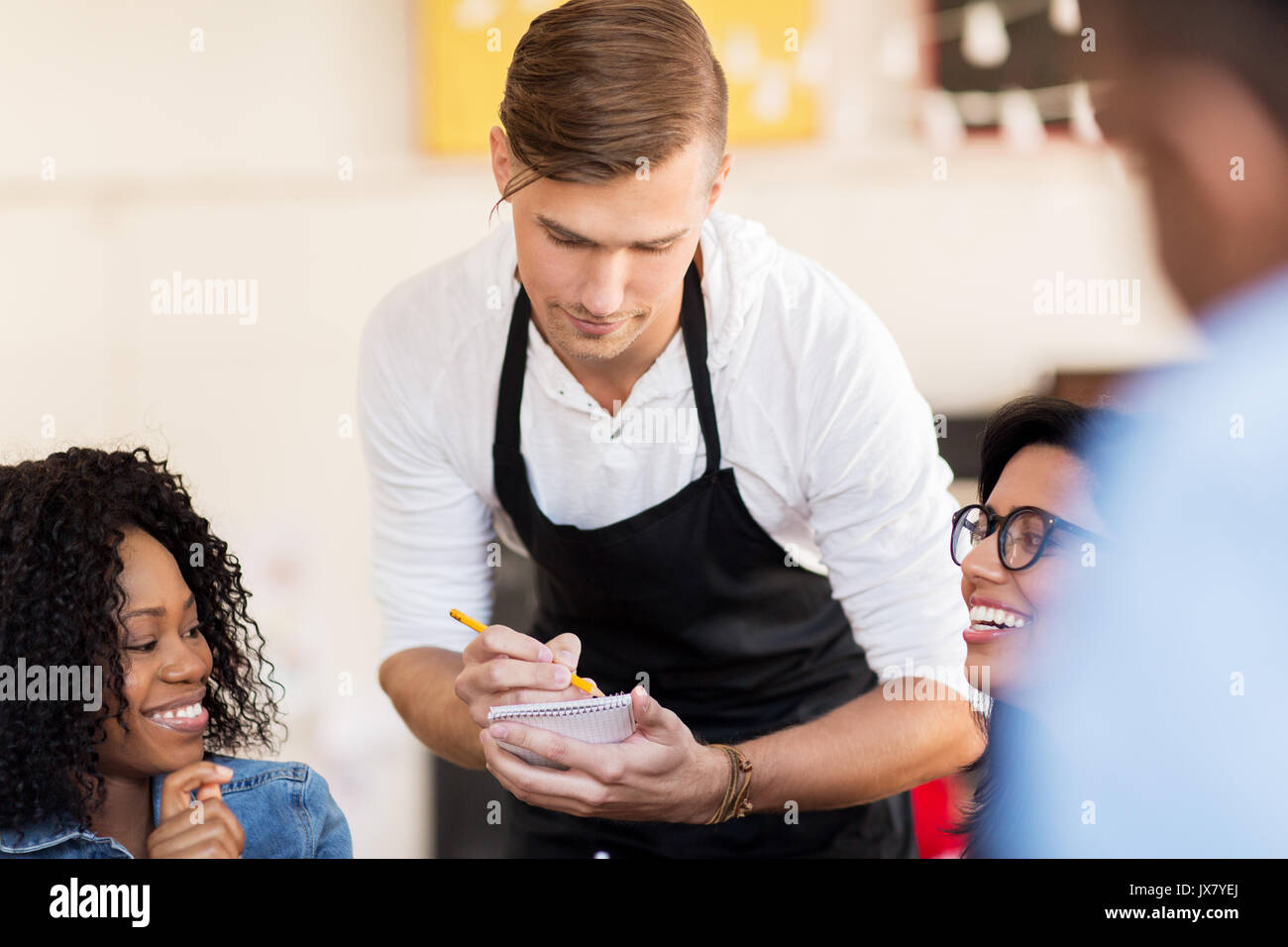 customers and waiter with notepad or restaurant Stock Photo - Alamy