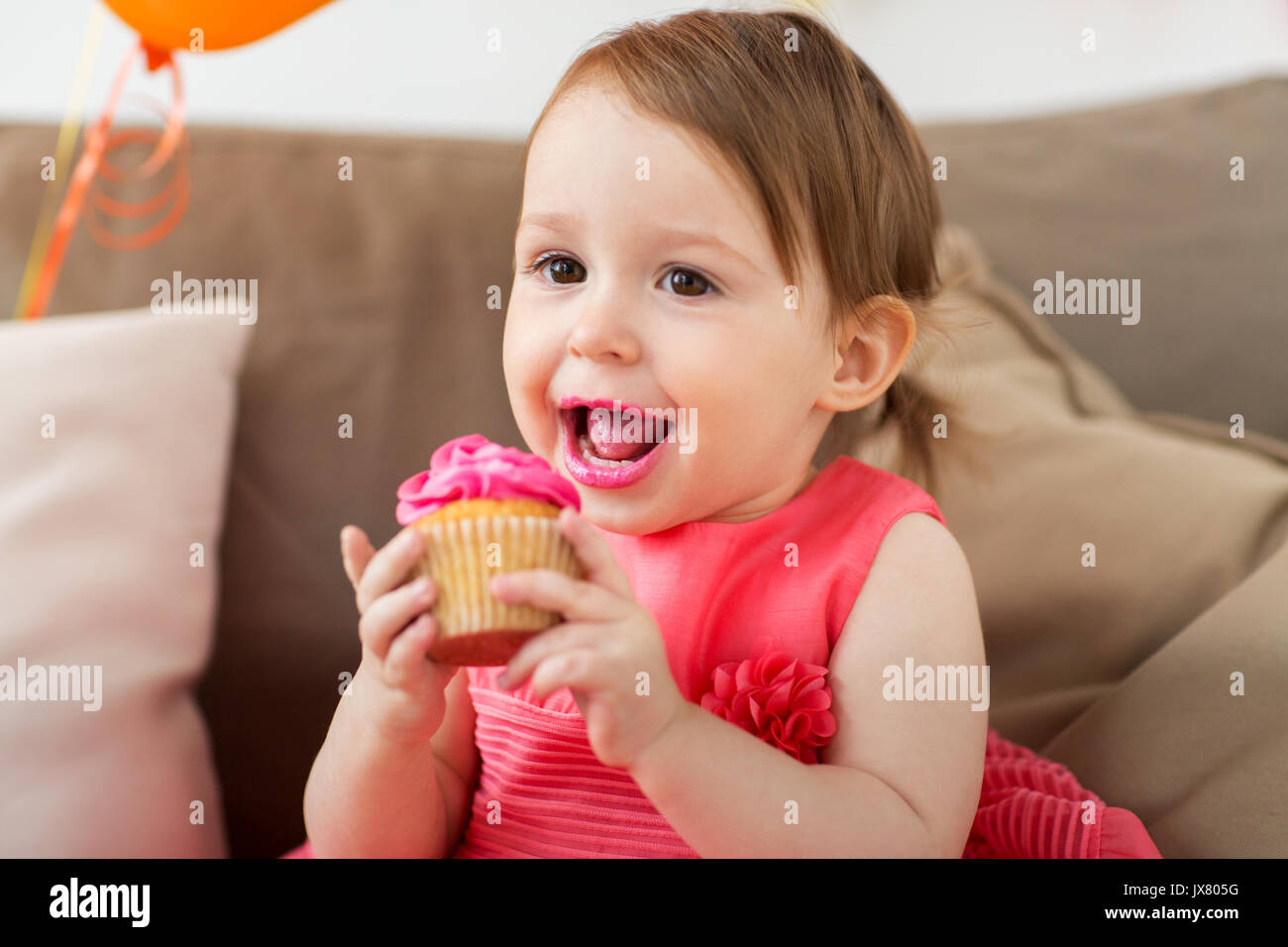 Little girl eating cupcake hires stock photography and images Alamy