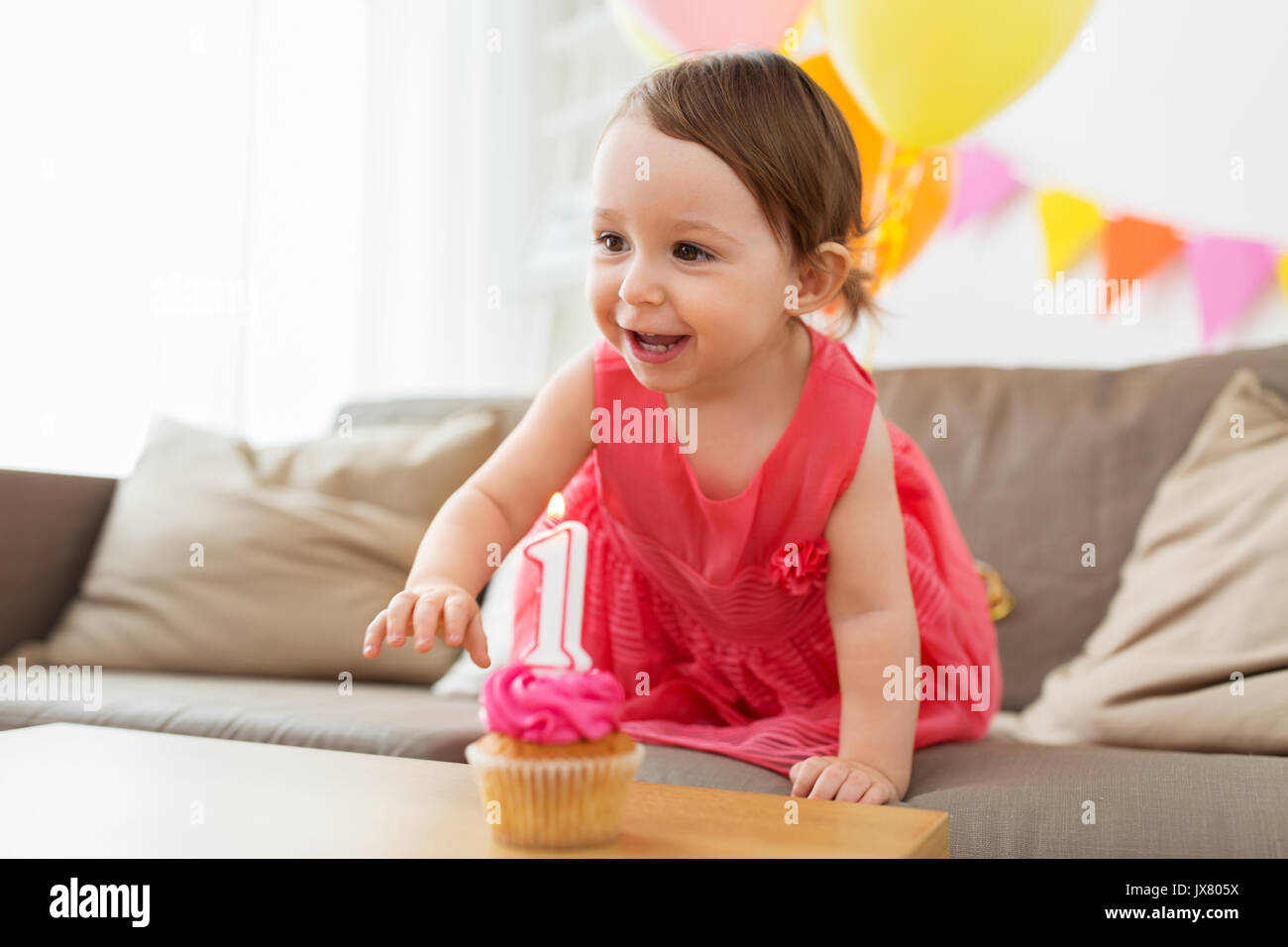 baby girl with birthday cupcake at home party Stock Photo - Alamy