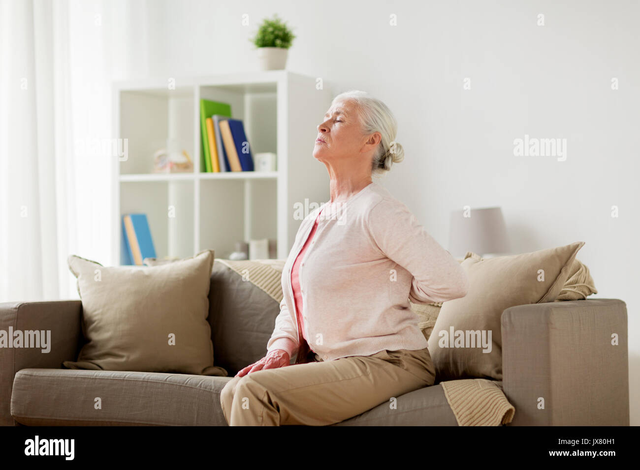 senior woman suffering from pain in back at home Stock Photo - Alamy