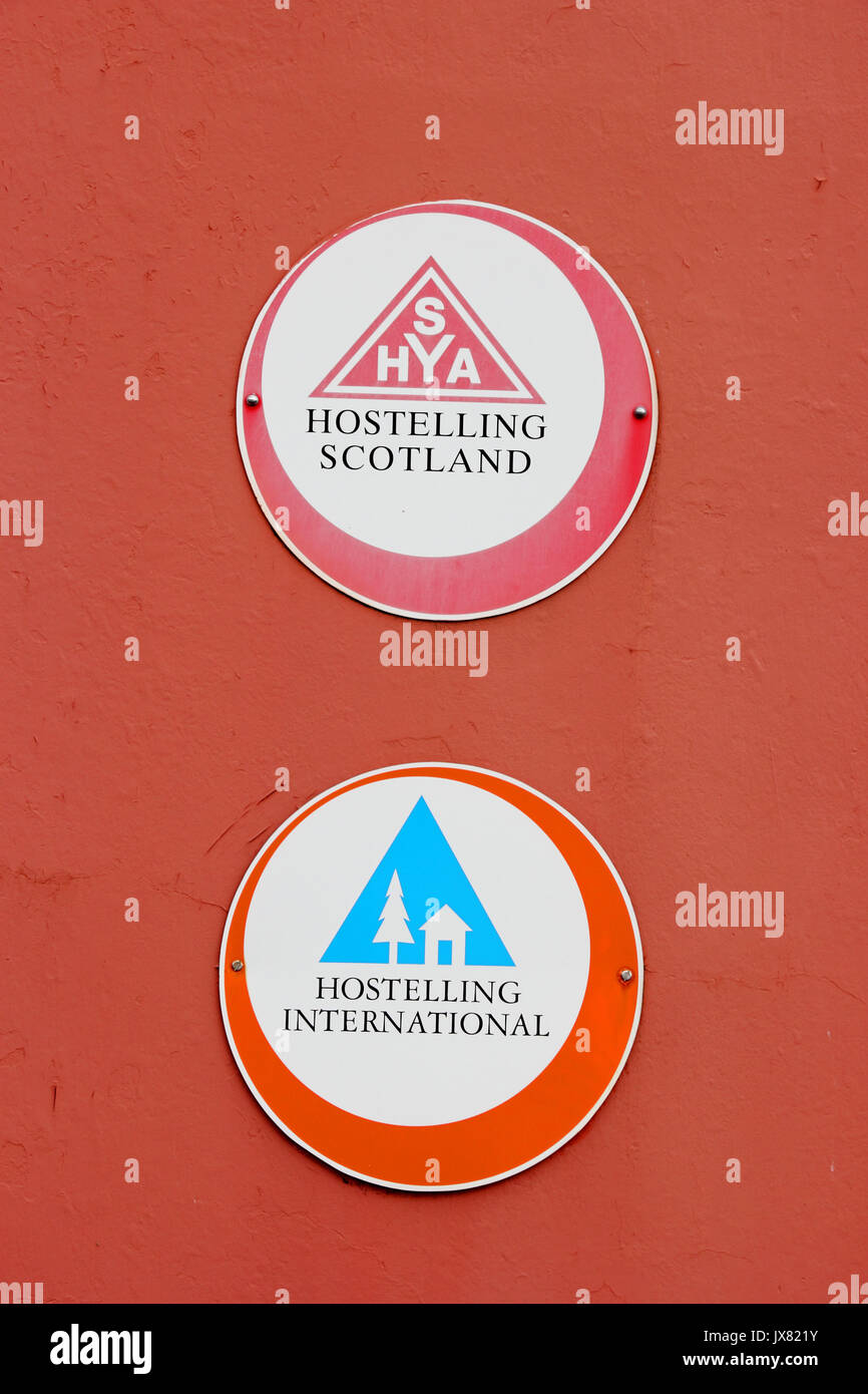 Scottish Youth Hostels Association and Hostelling International signs on painted red wall Stock Photo