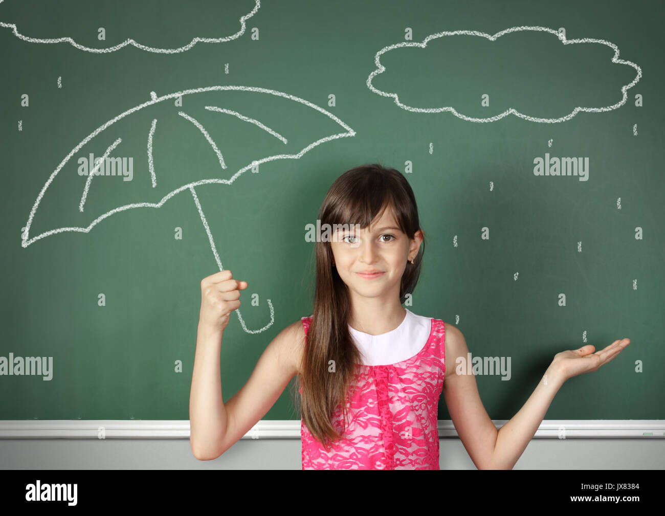 child hold umbrella near school blackboard, weather concept Stock Photo