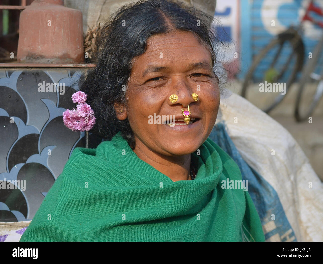 Indian Adivasi woman with two nose studs and nose-septum jewellery smiles for the camera. Stock Photo