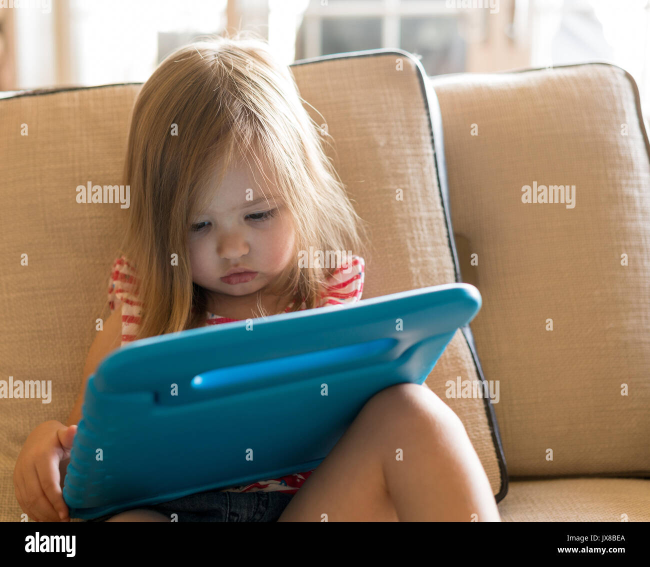 Preschool girl using a tablet computer at home Stock Photo - Alamy