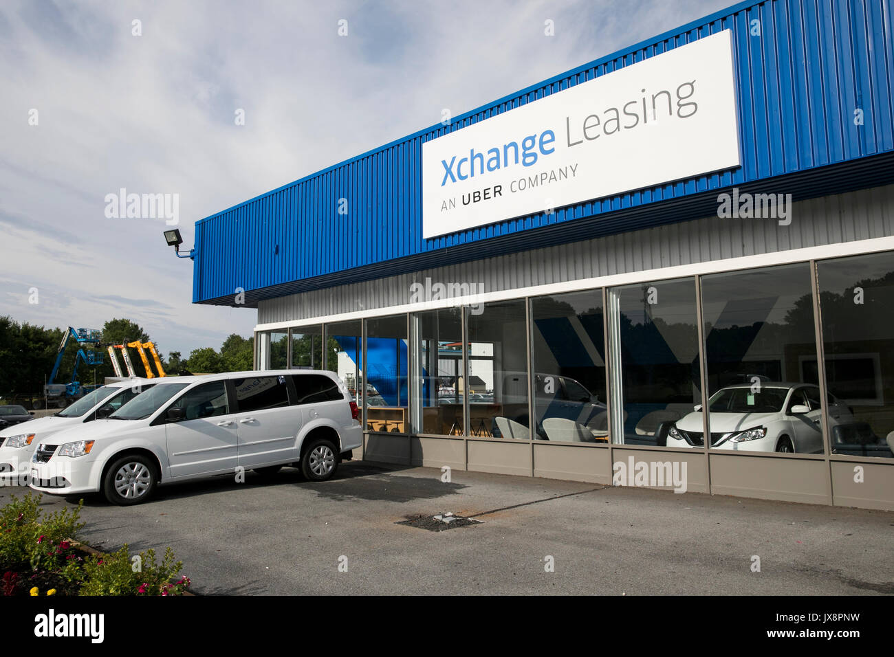 A logo sign and vehicles outside of a facility occupied by Xchange