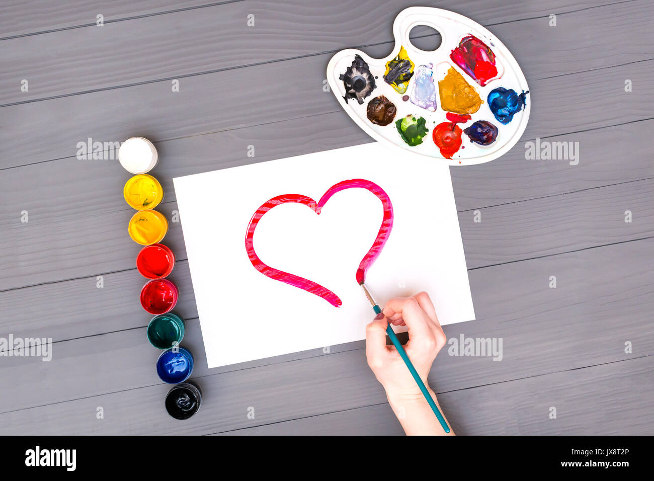 Hand draws heart on sheet Stock Photo Alamy