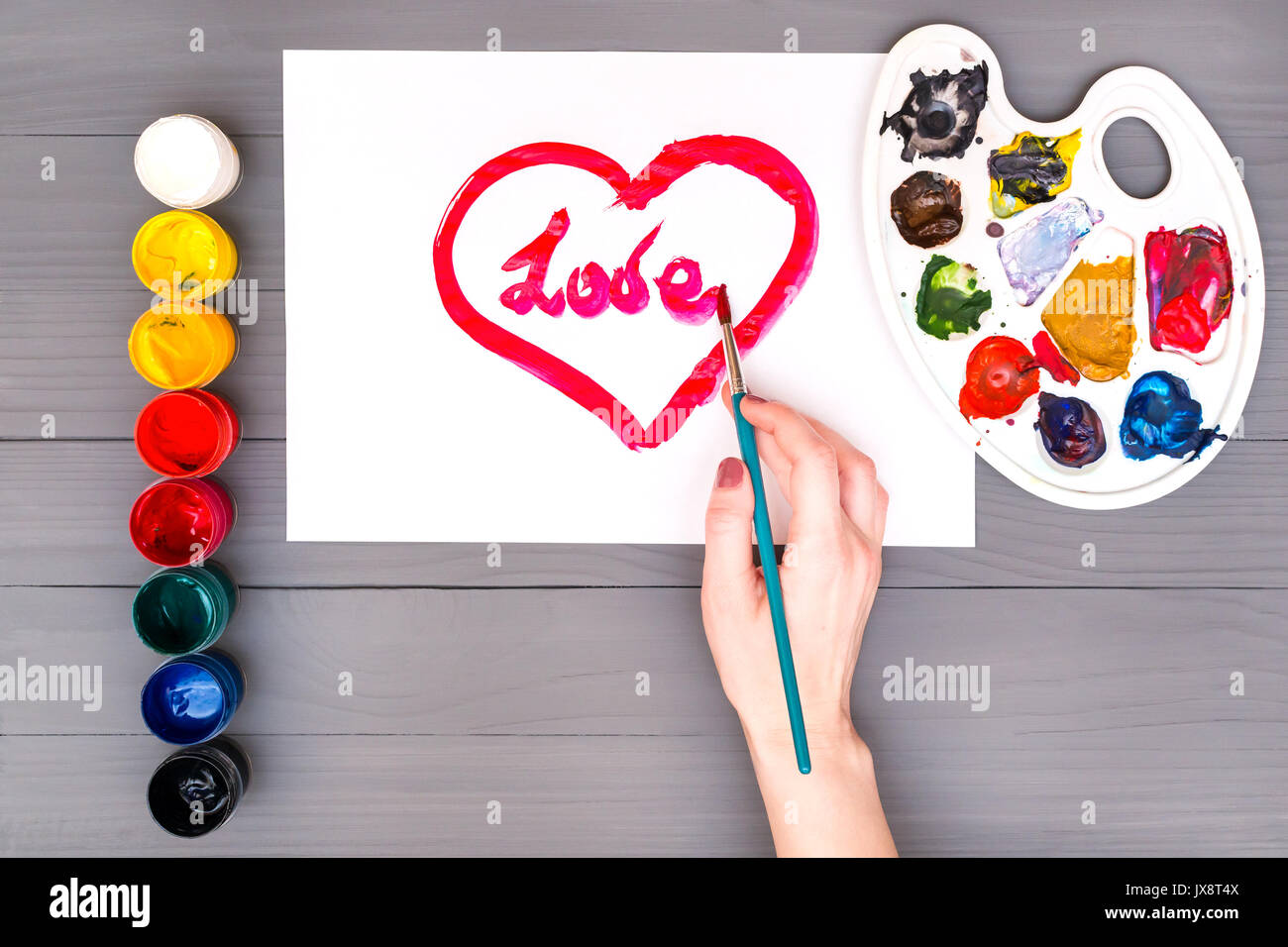 Hand draws heart on sheet Stock Photo Alamy