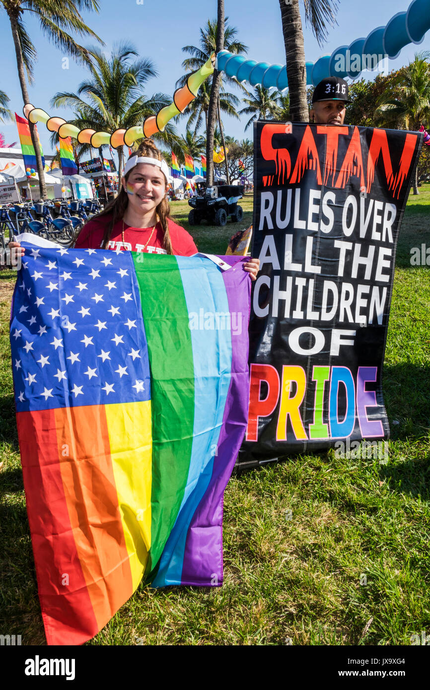 Miami Beach Florida,Lummus Park,Gay Pride Week,LGBTQ,LGBT,Miami Beach,Pride Festival,rainbow flag,counter protester,Conservative Christian,Christians, Stock Photo