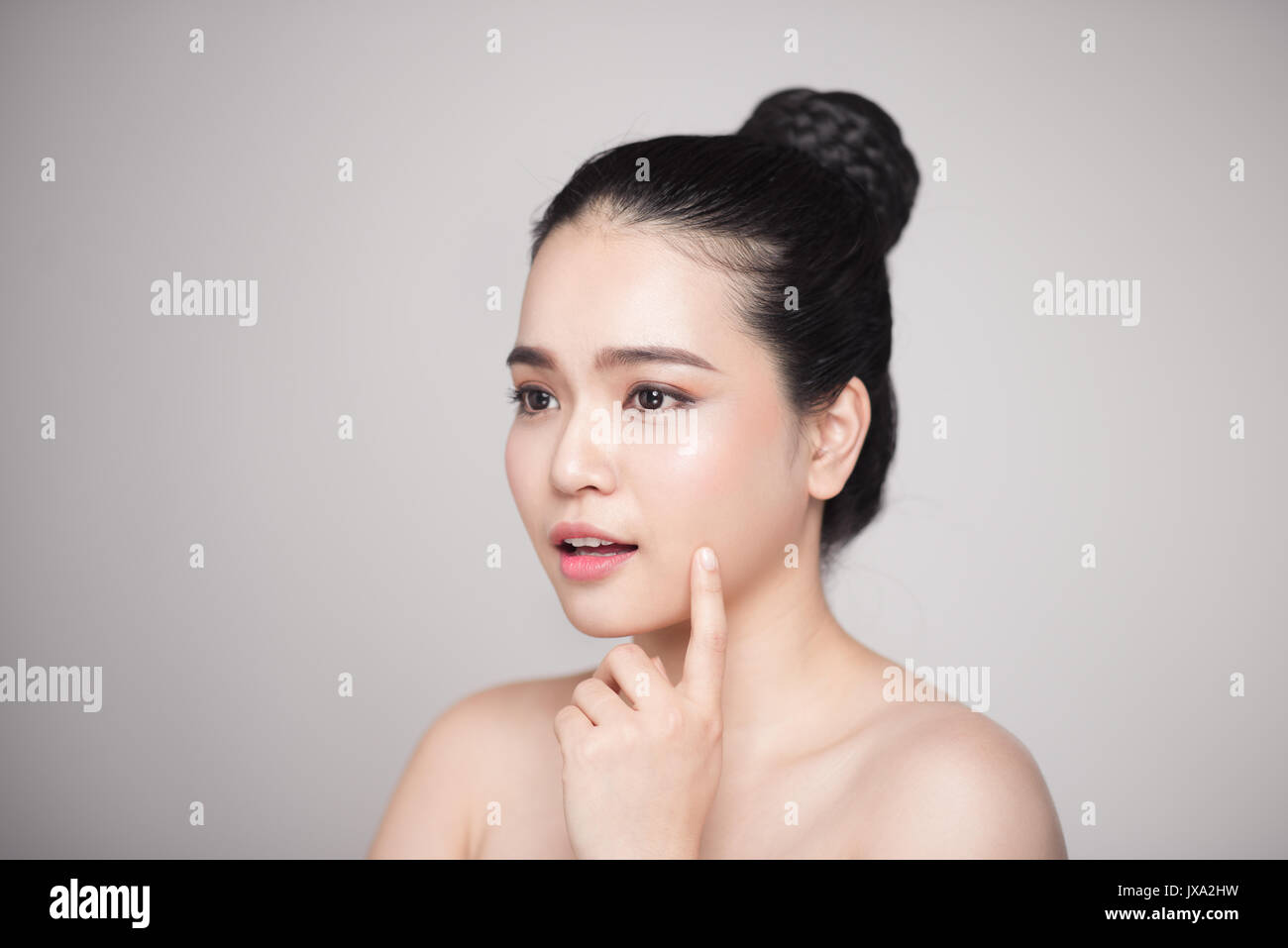 Happy smiling beautiful asian woman touching her face Stock Photo - Alamy
