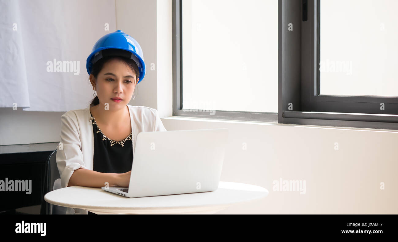 Female engineers are using a computer, system analysis and design. in