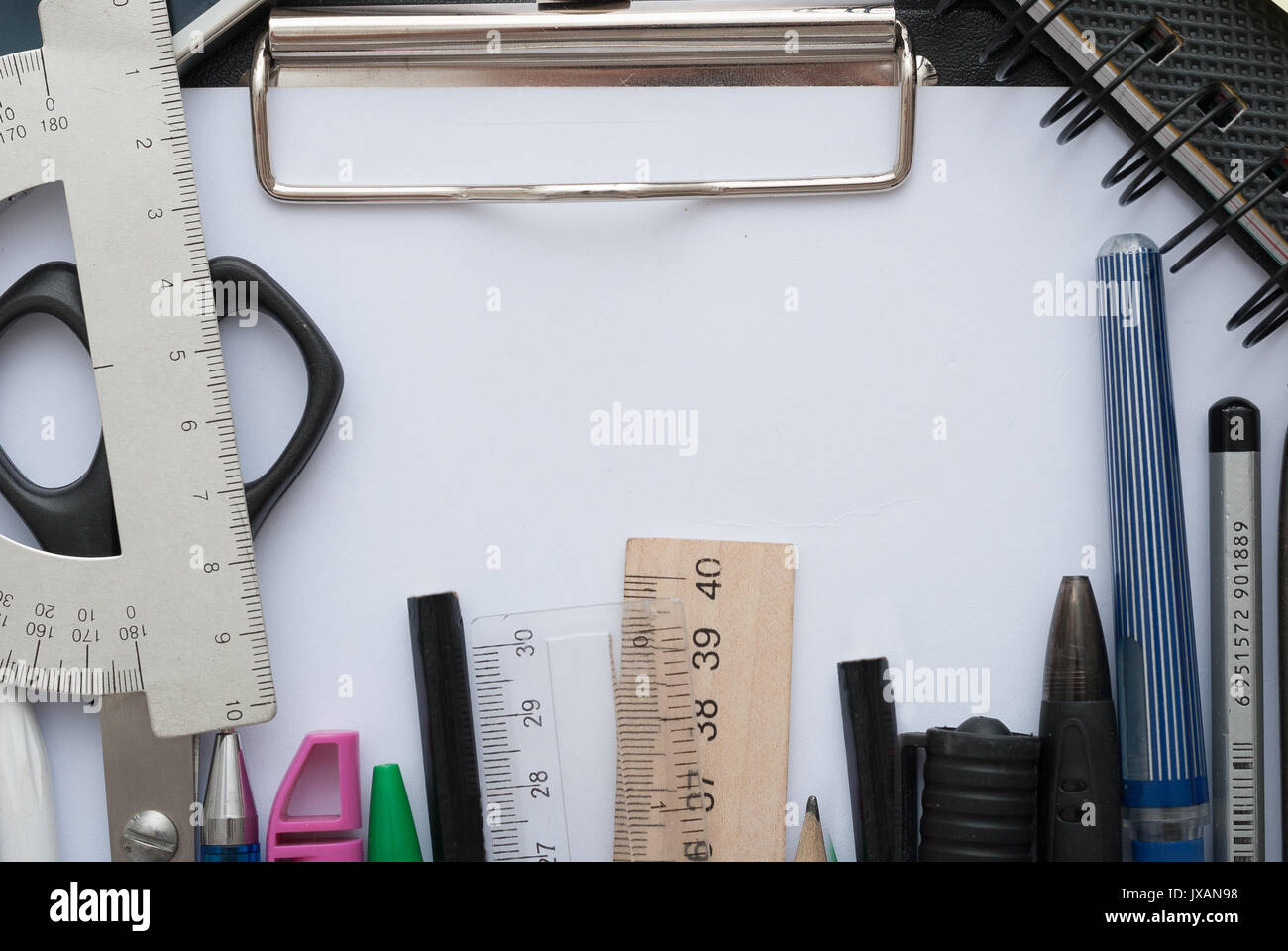 School set with back to school inscription in notebook and stationery on wooden background Stock Photo