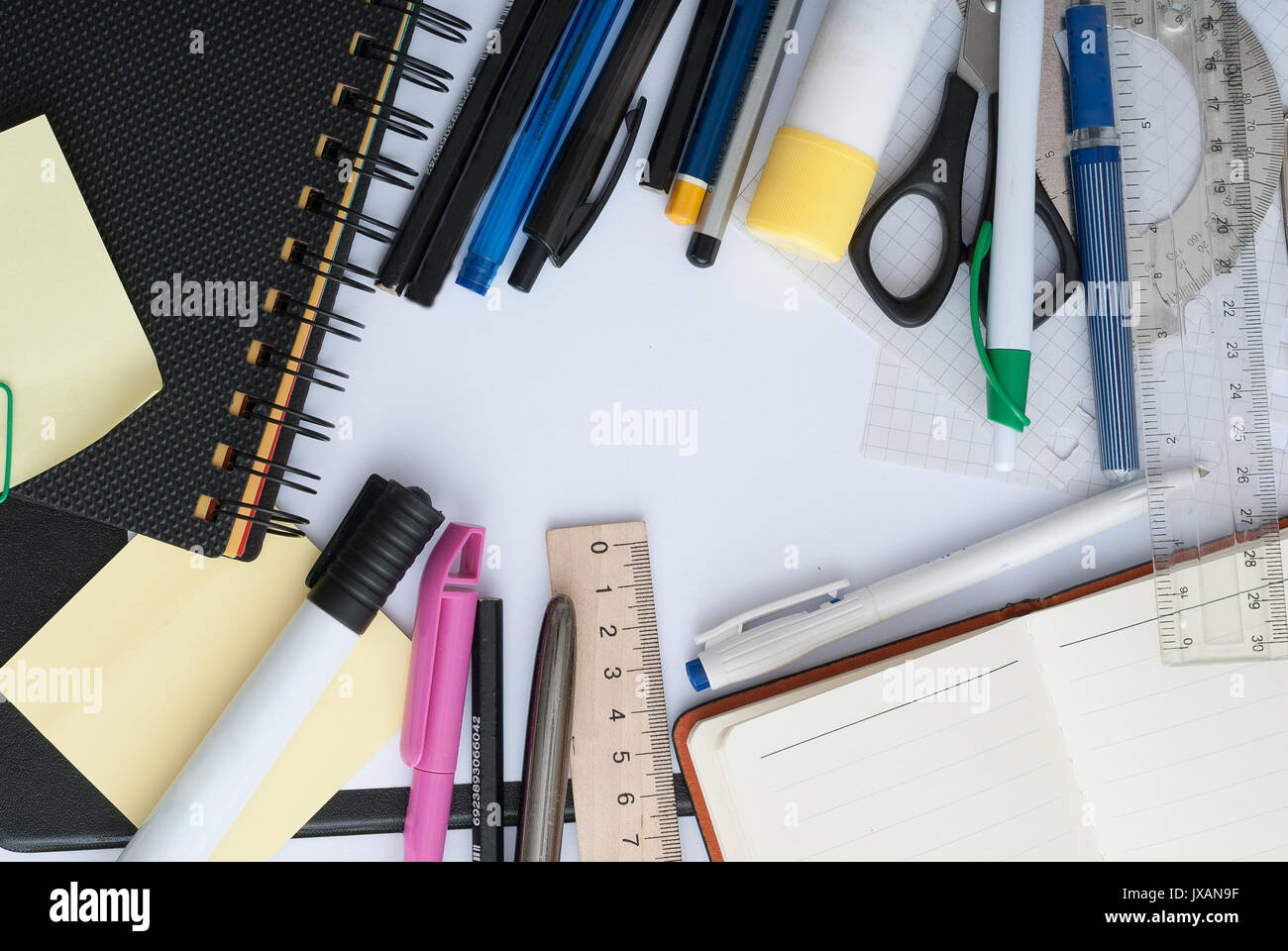 School set with back to school inscription in notebook and stationery on wooden background Stock Photo