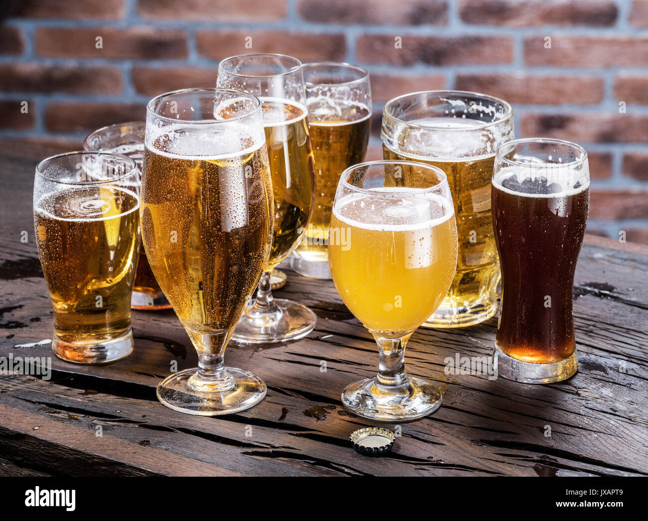 Different glasses of beer on the wooden table. Stock Photo