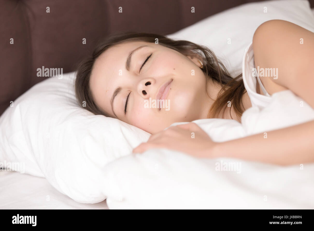 Pretty girl resting in bed, good deep healthy sleep, headshot Stock Photo