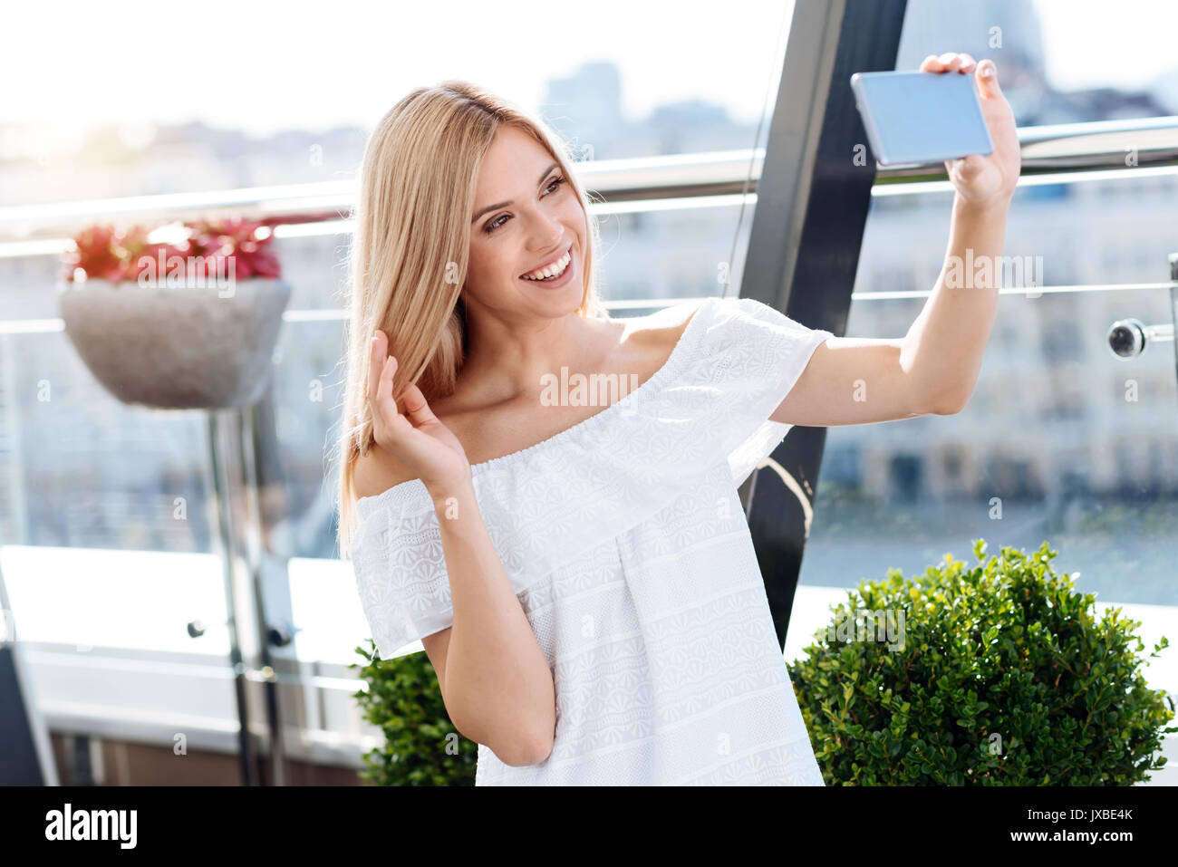 Happy delighted woman taking a selfie Stock Photo