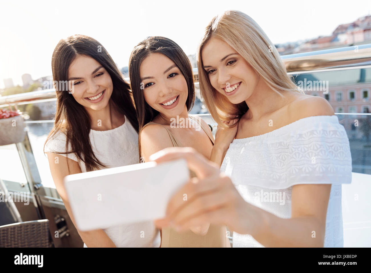 Delighted happy woman taking photos Stock Photo