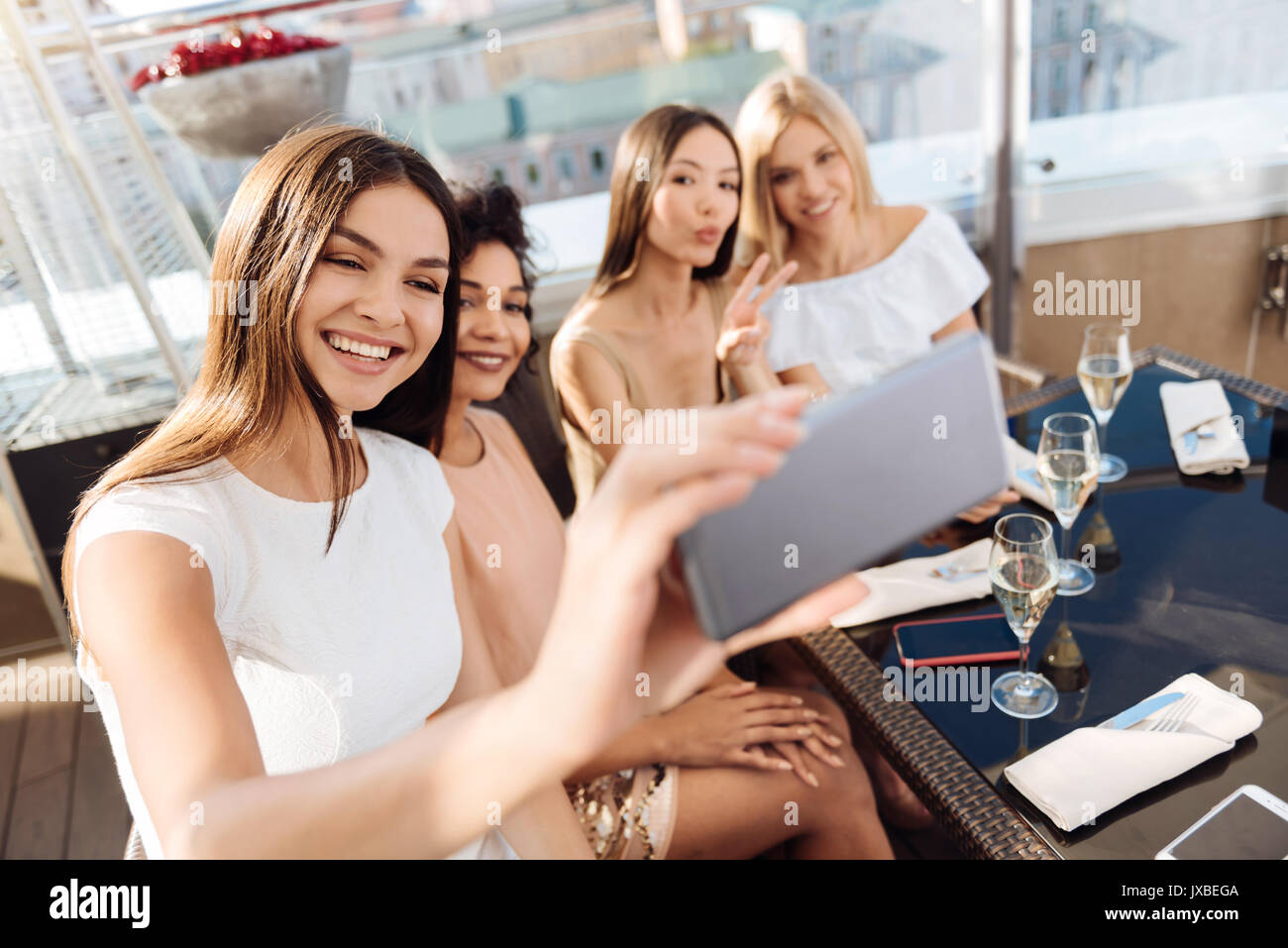 Happy charming woman taking a selfie Stock Photo