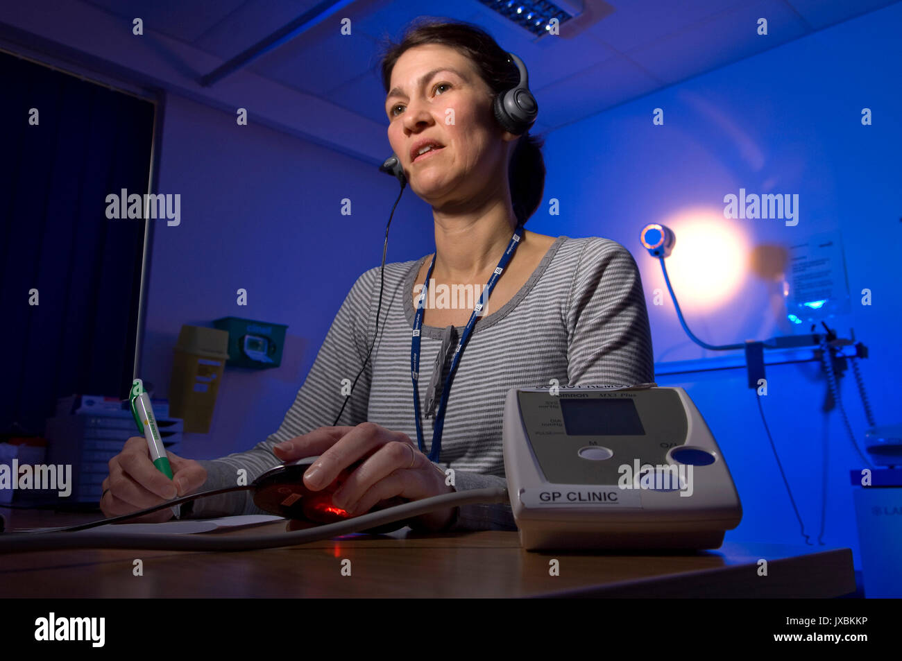 Michelle Davidson (Queen's Nurse) doing out-of-hours telephone triage at the GP Clinic, based at Weston General Hospital, Weston-Super-Mare, Somerset. Stock Photo