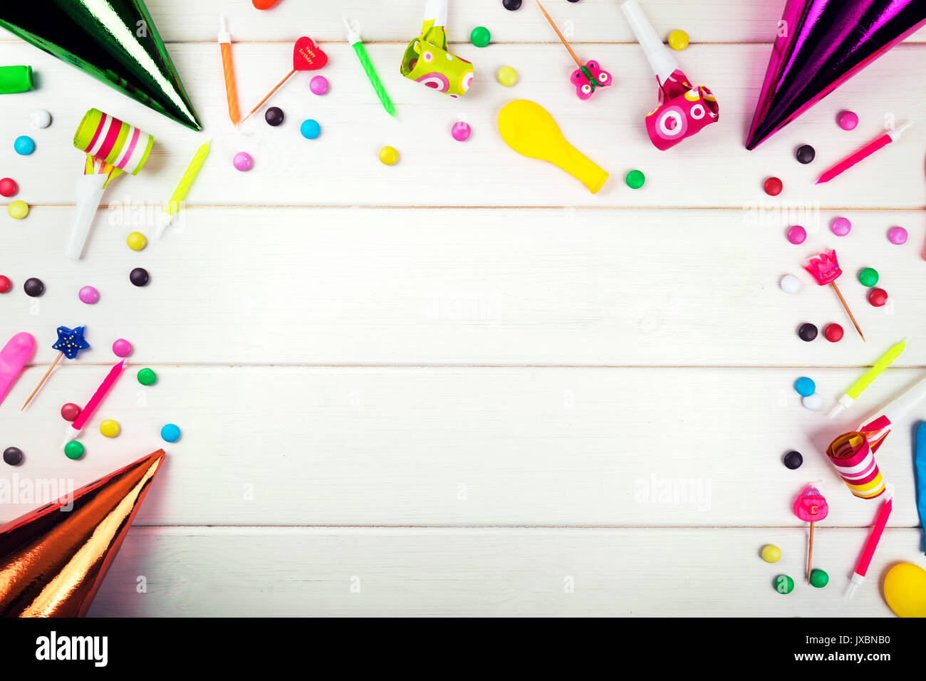 birthday party items and decorations on white wood background. top view Stock Photo