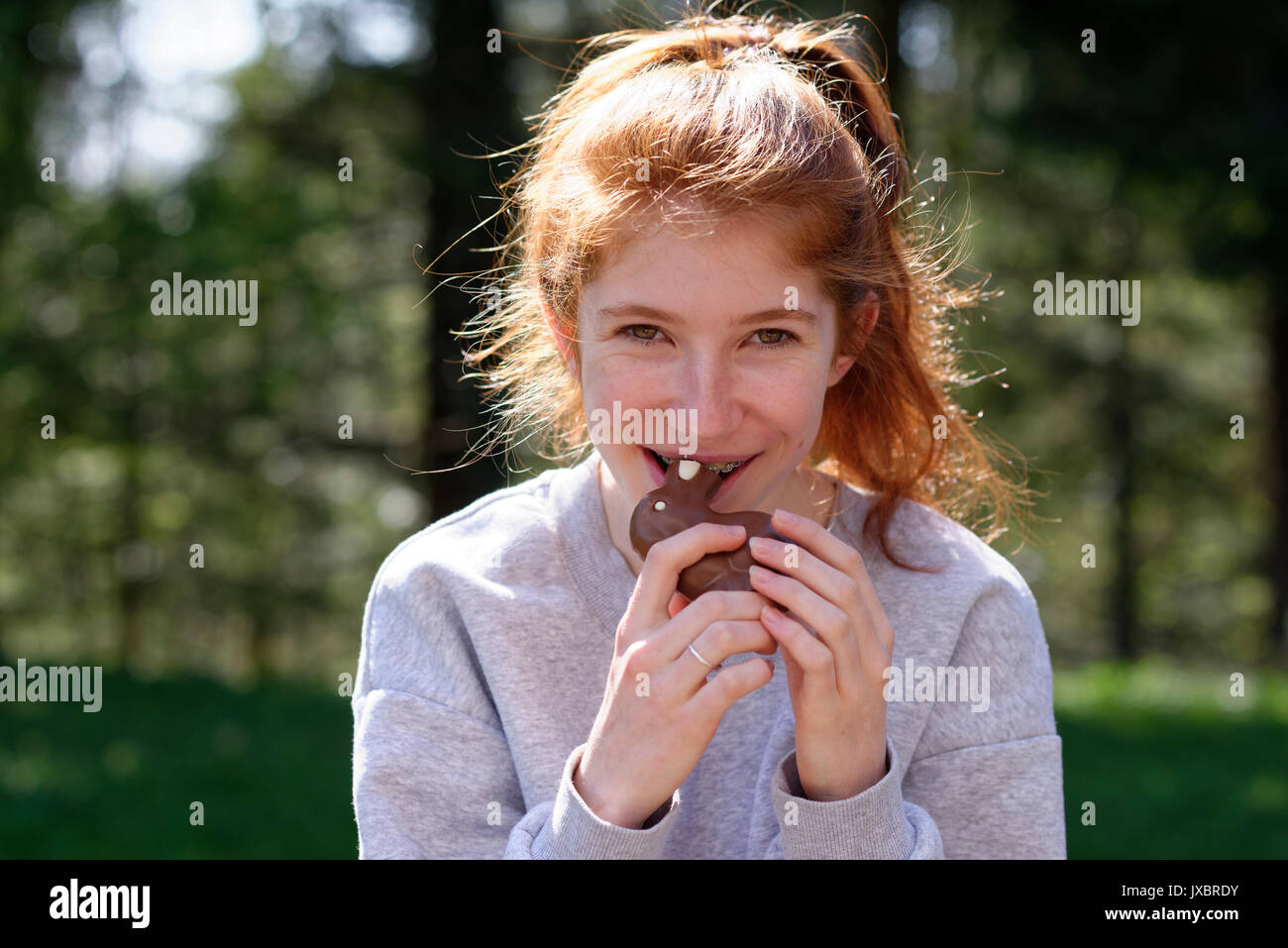 Young girl with chocolate Easter bunny, biting in Easter bunny, Easter, Upper Bavaria, Bavaria, Germany Stock Photo