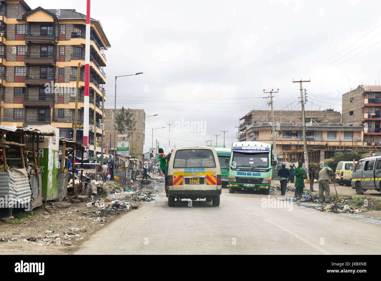 Matatu mini bus and other buses driving on city street in Nairobi, Kenya Stock Photo