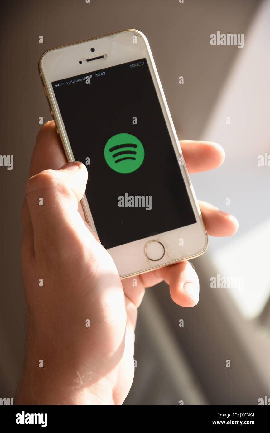 White Apple SE Mobile phone showing the Spotify Logo on it's screen Stock Photo