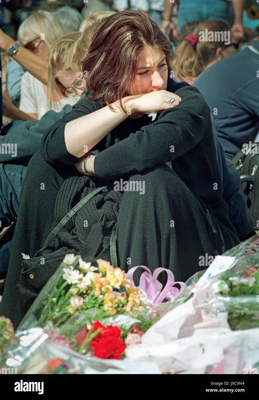 31 August 1997, 4am local time, at the Pitié-Salpêtrière Hospital, Paris. The announcement was made that most famous woman in the world had just died in a tragic car crash in a Parisian tunnel.  Princess Diana's death sent the world into wide spread grief.   Mourners grieve outside Buckingham Palace on the day of her funeral. Stock Photo