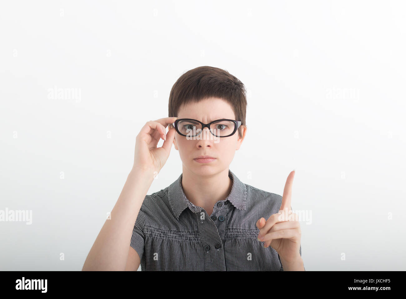 Funny strict teacher with glasses shakes his finger on white background
