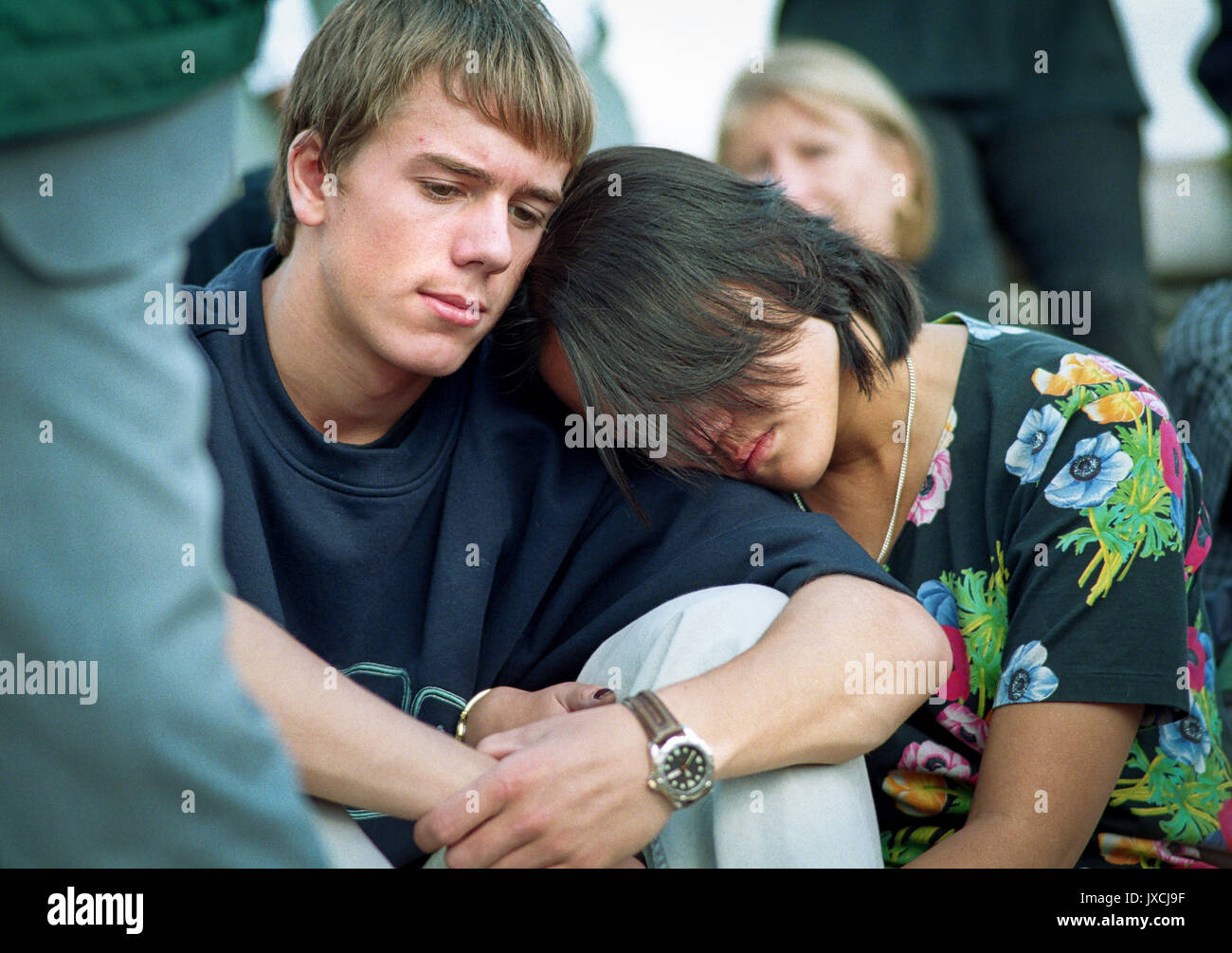Princess Diana's death sent the world into wide spread grief.   Mourners grieve outside Buckingham Palace on the day of her funeral. Stock Photo