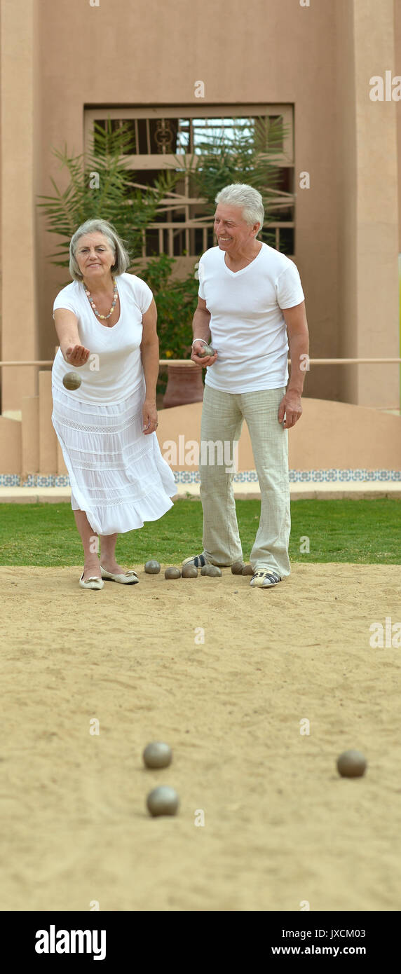 couple throwing balls in sand Stock Photo Alamy