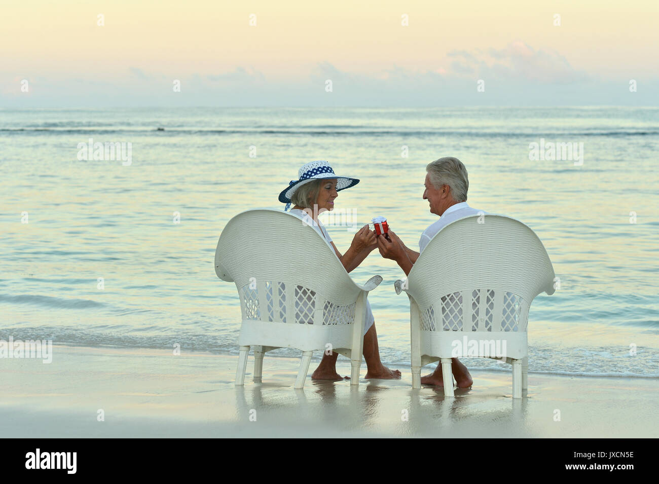 Old couple on beach chairs hi-res stock photography and images - Alamy