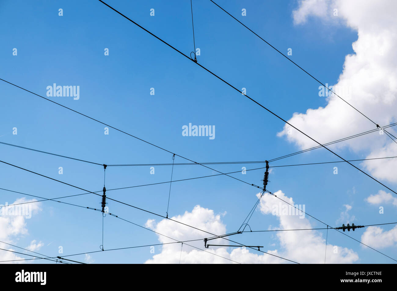 Overhead electric wires  that provide power for the railway trains Stock Photo