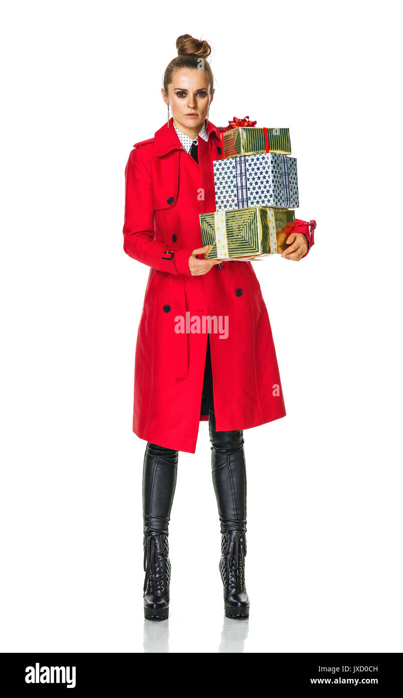 Keep the autumn bright. Full length portrait of trendy woman in red coat isolated on white with Christmas present boxes Stock Photo