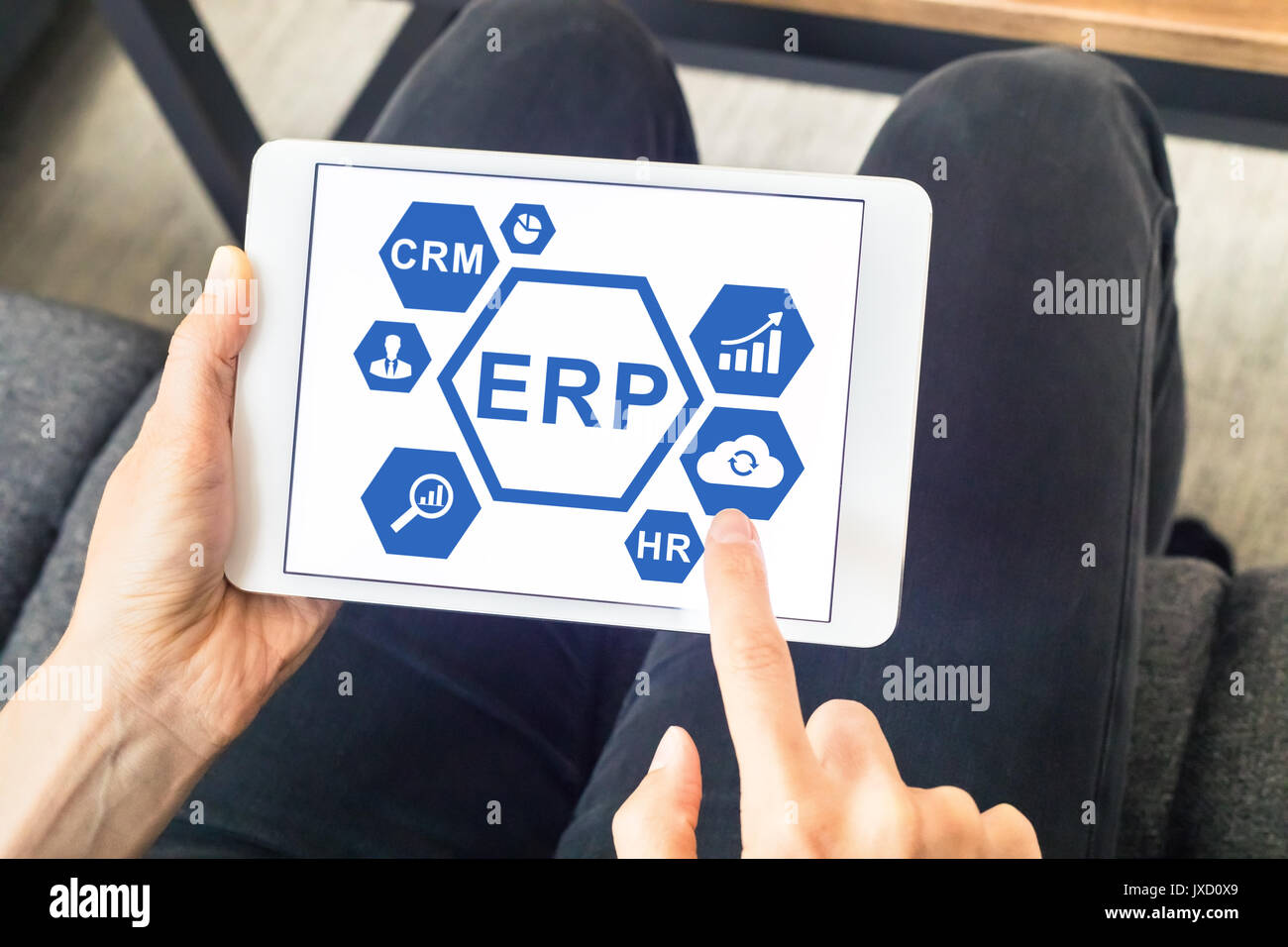 ERP (Enterprise Resource Planning) software app interface on a digital tablet computer screen with button and hand of manager Stock Photo