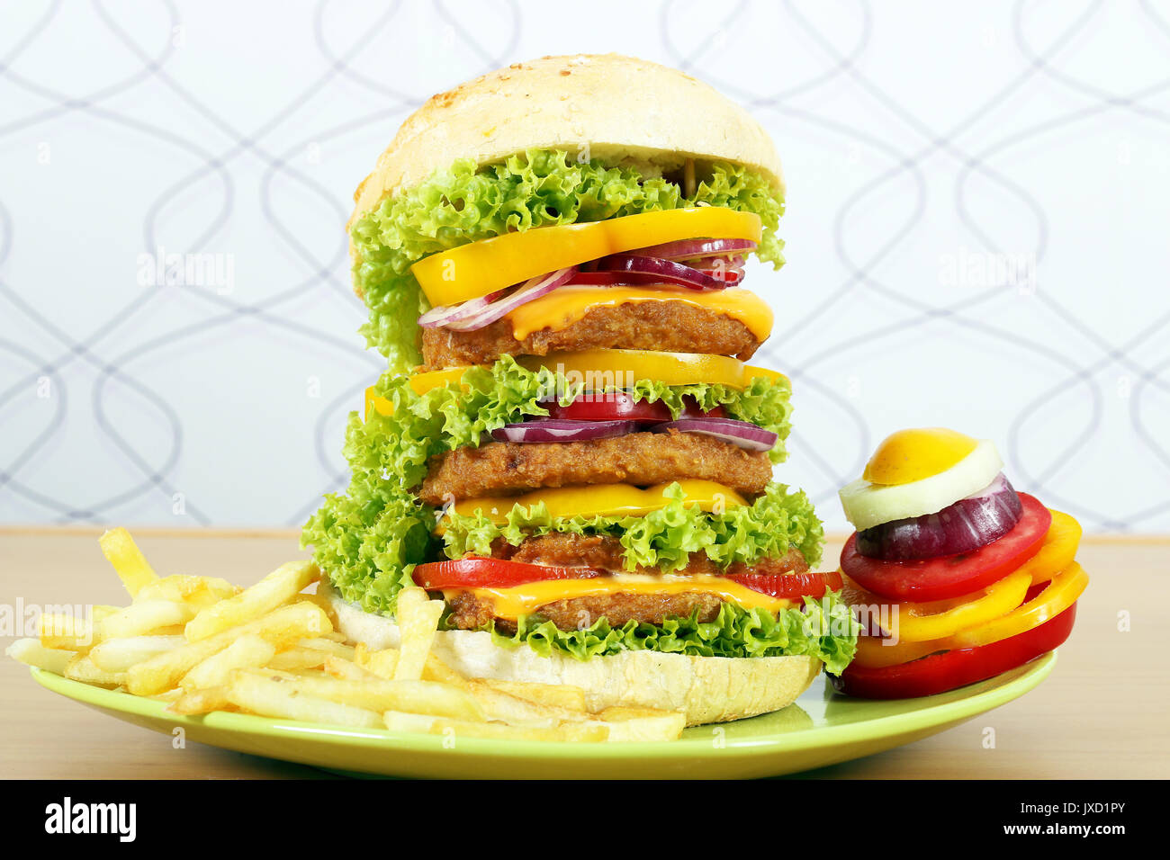 big hamburger with french fries and salad Stock Photo